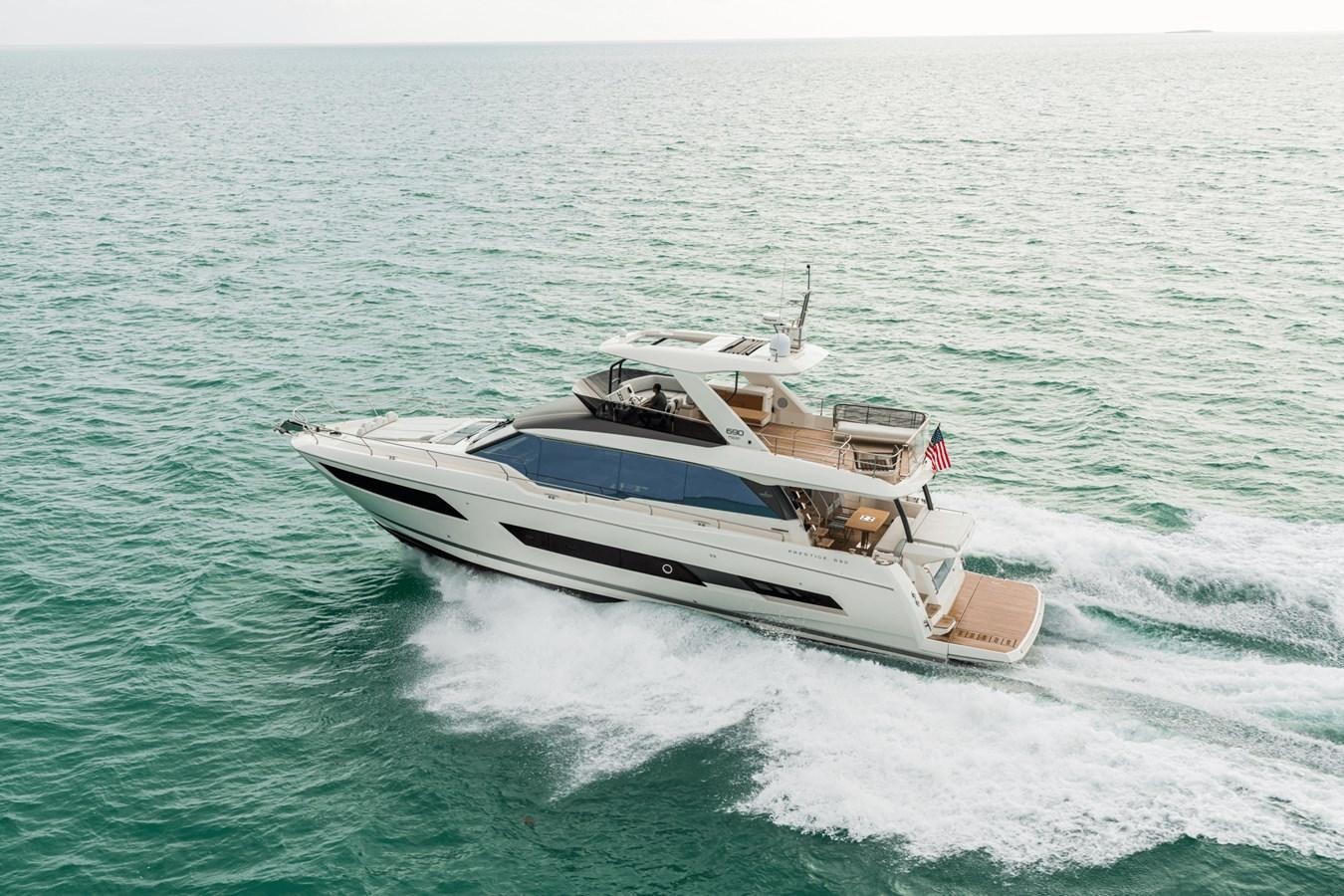 a boat on the water aboard 2021 PRESTIGE YACHTS 690 FLYBRIDGE Yacht for Sale