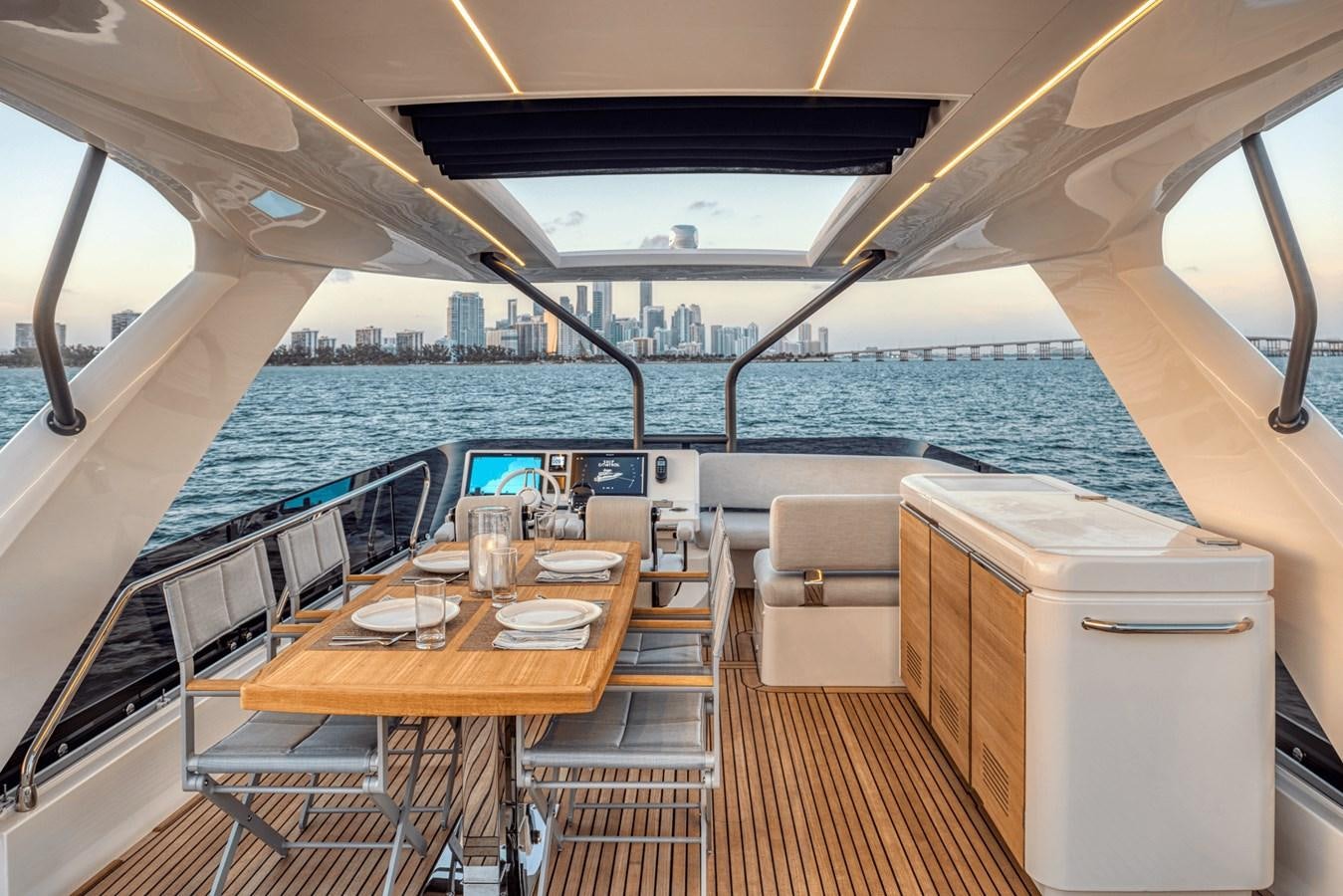 a boat with a table and chairs aboard 2021 PRESTIGE YACHTS 690 FLYBRIDGE Yacht for Sale