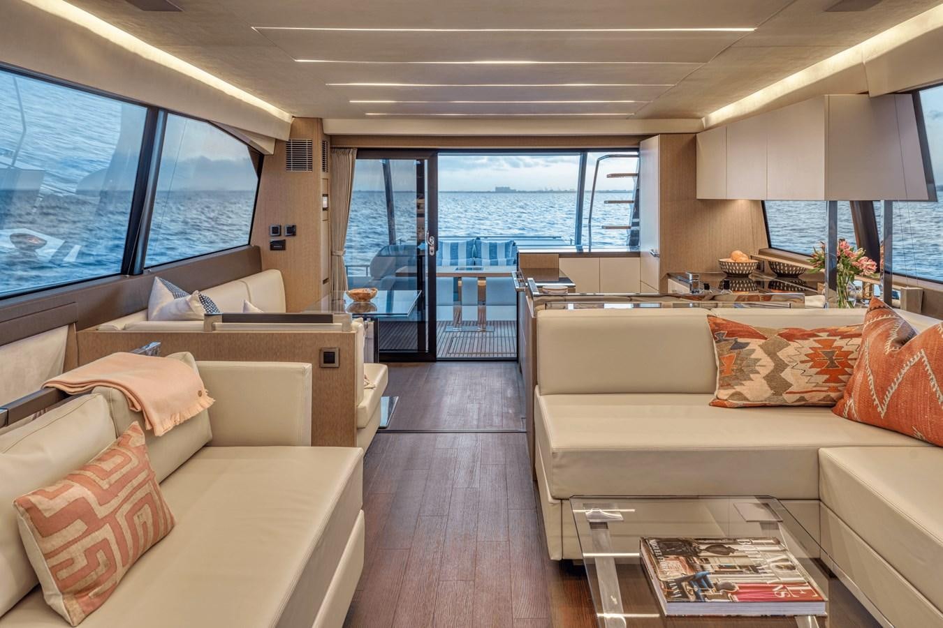 a living room with a large window aboard 2021 PRESTIGE YACHTS 690 FLYBRIDGE Yacht for Sale