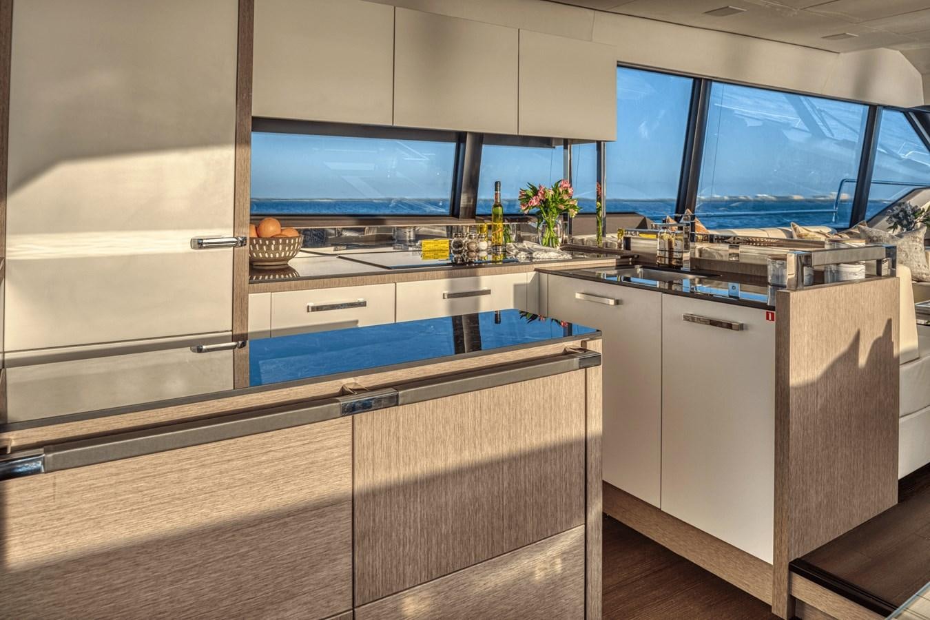 a kitchen with a large tv aboard 2021 PRESTIGE YACHTS 690 FLYBRIDGE Yacht for Sale