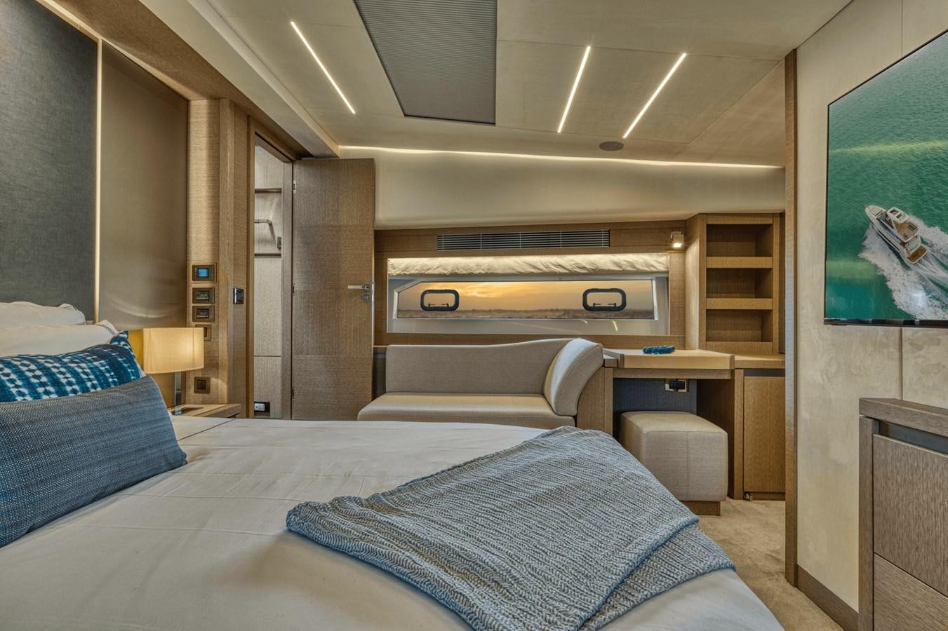a bedroom with a bed and a desk aboard 2021 PRESTIGE YACHTS 690 FLYBRIDGE Yacht for Sale