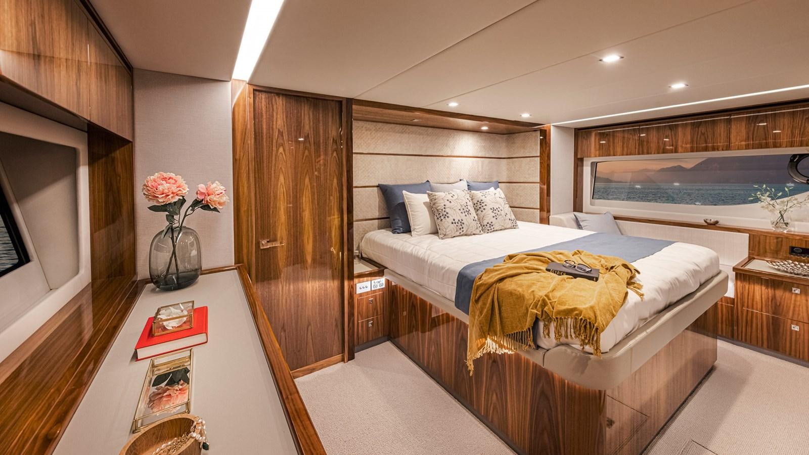 a bedroom with a bed and a desk aboard 645 SUV Yacht for Sale