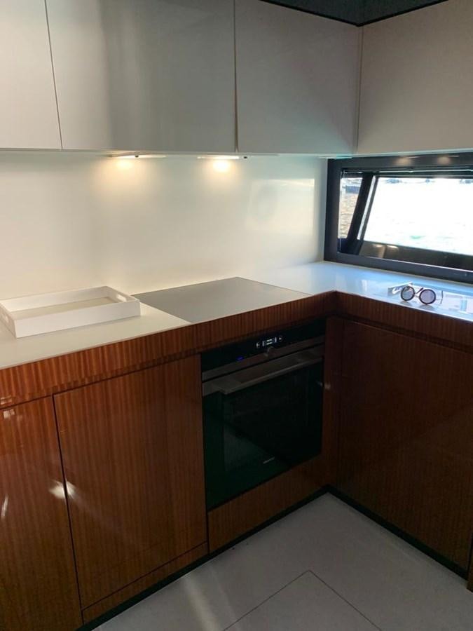 a kitchen with a microwave oven aboard 2020 RIVA 66 RIBELLE Yacht for Sale
