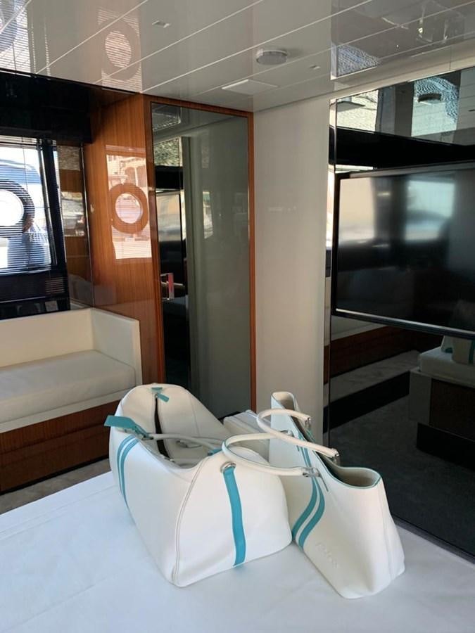 a white chair in a room aboard 2020 RIVA 66 RIBELLE Yacht for Sale