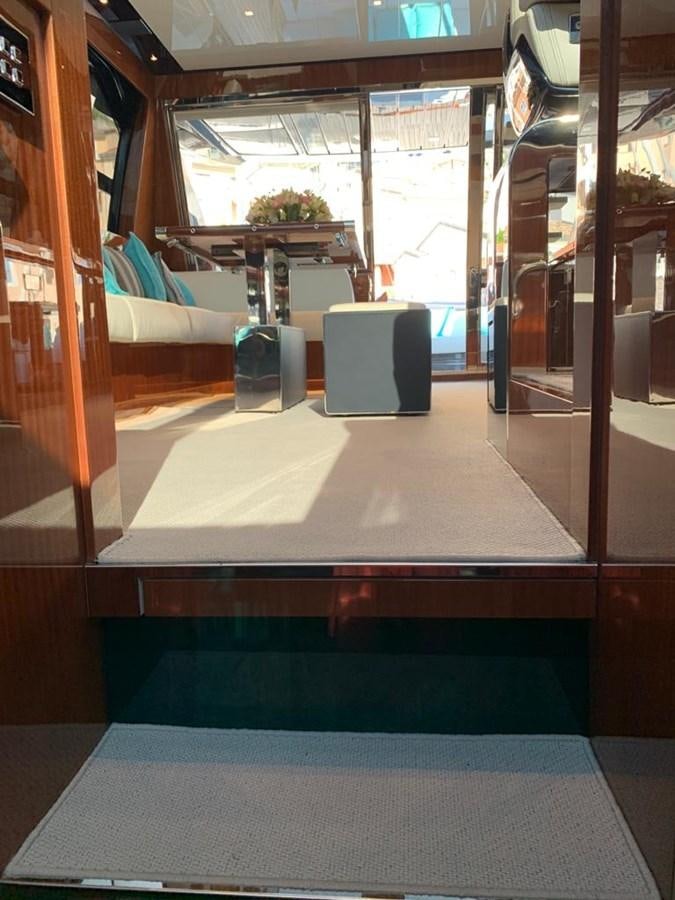 a room with a table and chairs aboard 2020 RIVA 66 RIBELLE Yacht for Sale
