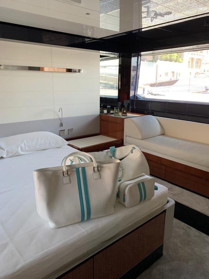 a room with a bed and a window aboard 2020 RIVA 66 RIBELLE Yacht for Sale