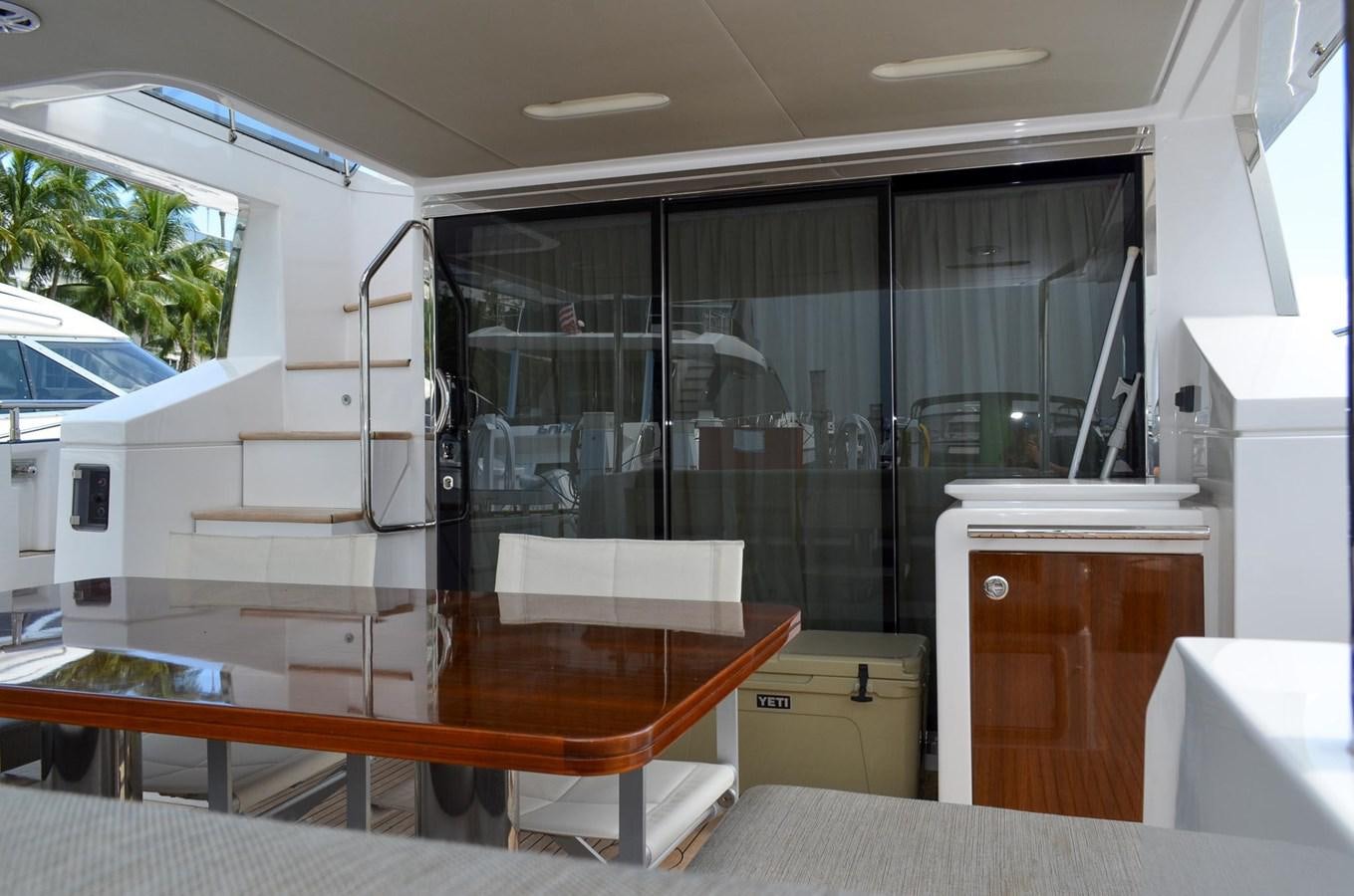 a room with a table and a window aboard CERULEAN Yacht for Sale