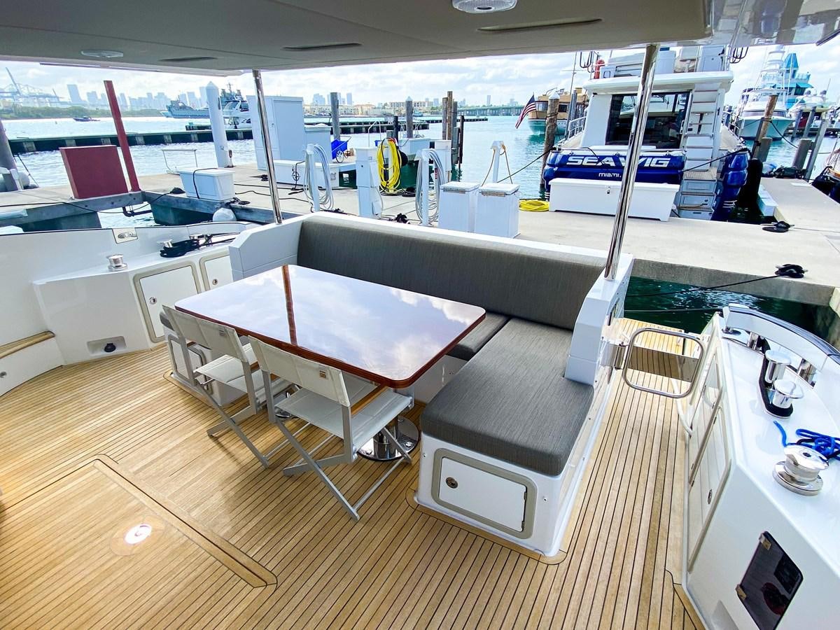 a room with tables and chairs aboard CERULEAN Yacht for Sale