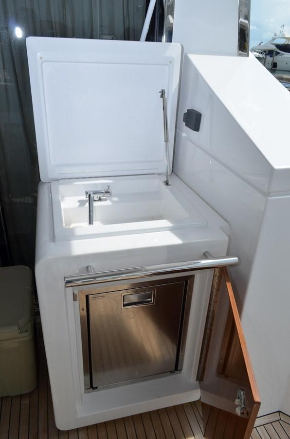 a white refrigerator in a kitchen aboard CERULEAN Yacht for Sale
