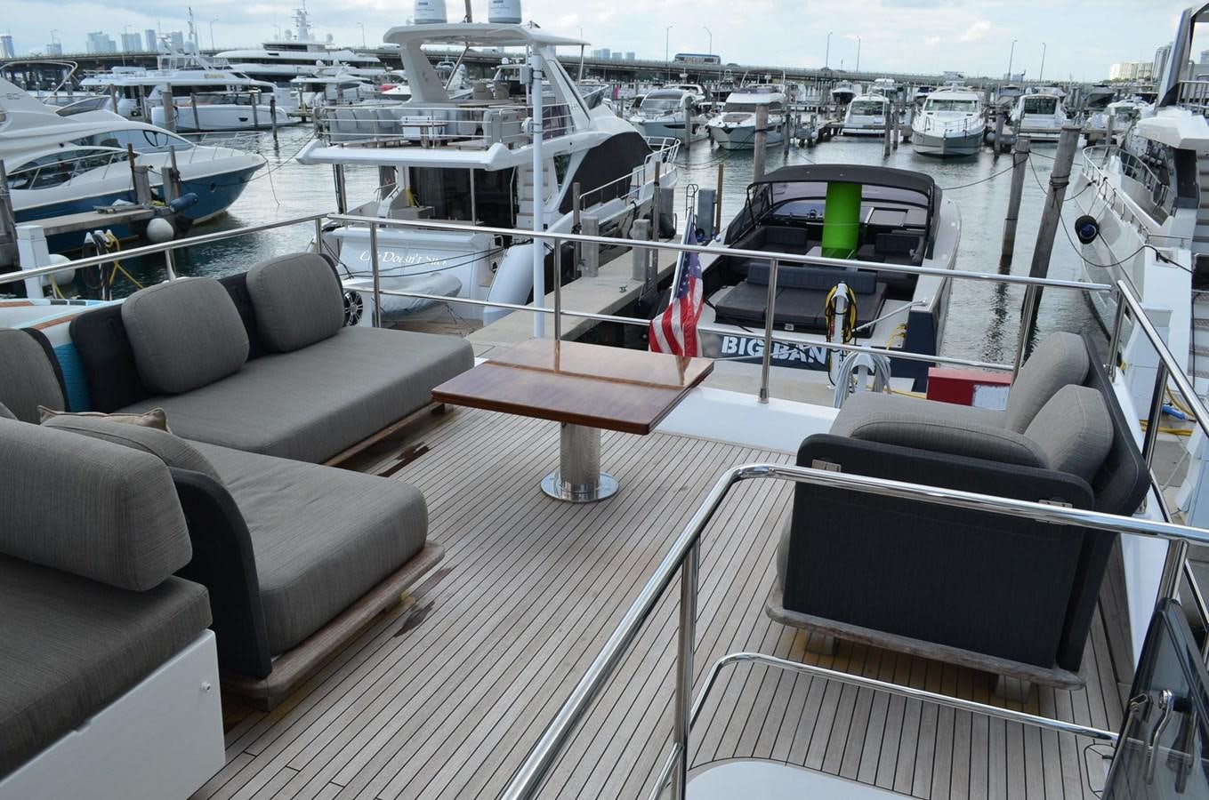 a deck with chairs and a boat on it aboard CERULEAN Yacht for Sale