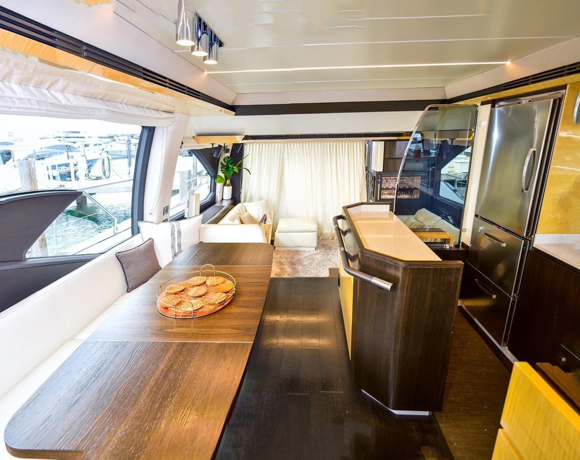 a room with a table and couches aboard CERULEAN Yacht for Sale