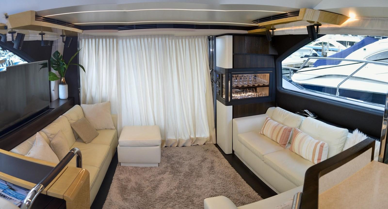 a living room with a couch and a television aboard CERULEAN Yacht for Sale