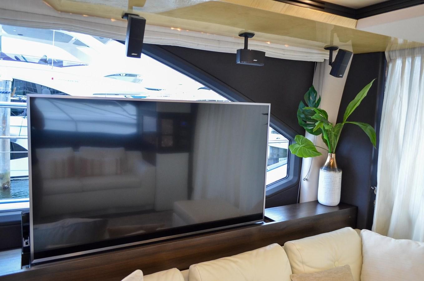 a living room with a large television aboard CERULEAN Yacht for Sale
