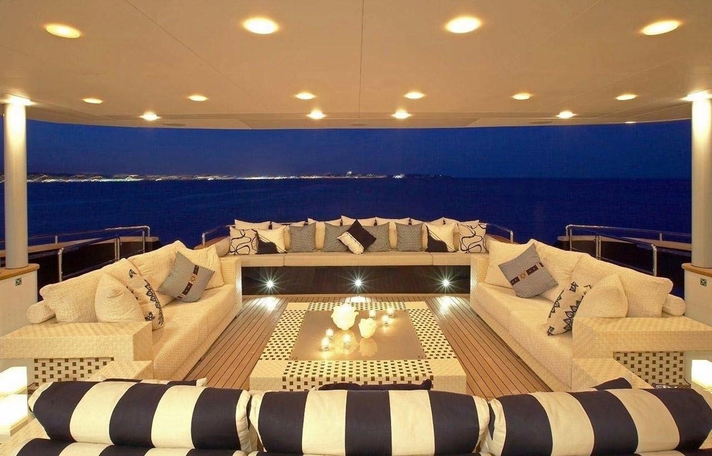 a large bed with a large blue wall behind it aboard BURKUT Yacht for Sale