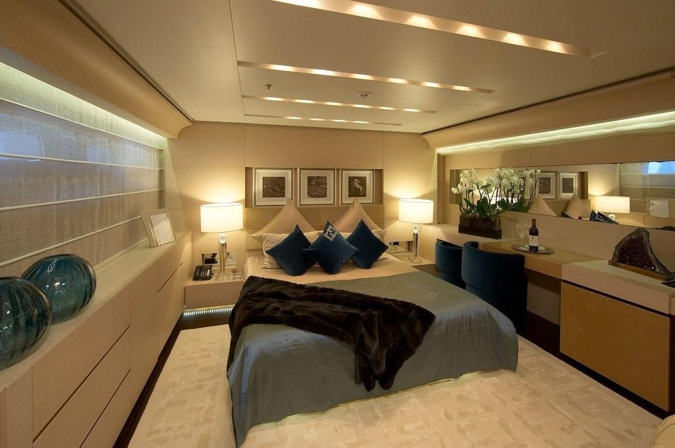 a hotel room with a bed and a desk aboard BURKUT Yacht for Sale