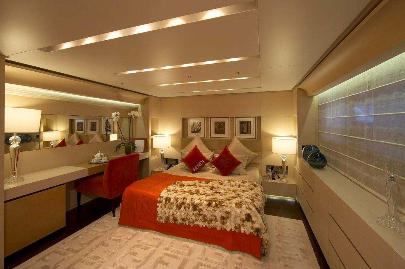 a hotel room with a bed and desk aboard BURKUT Yacht for Sale