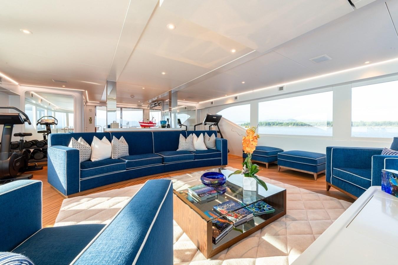a living room with a blue couch aboard WHITE STAR Yacht for Sale