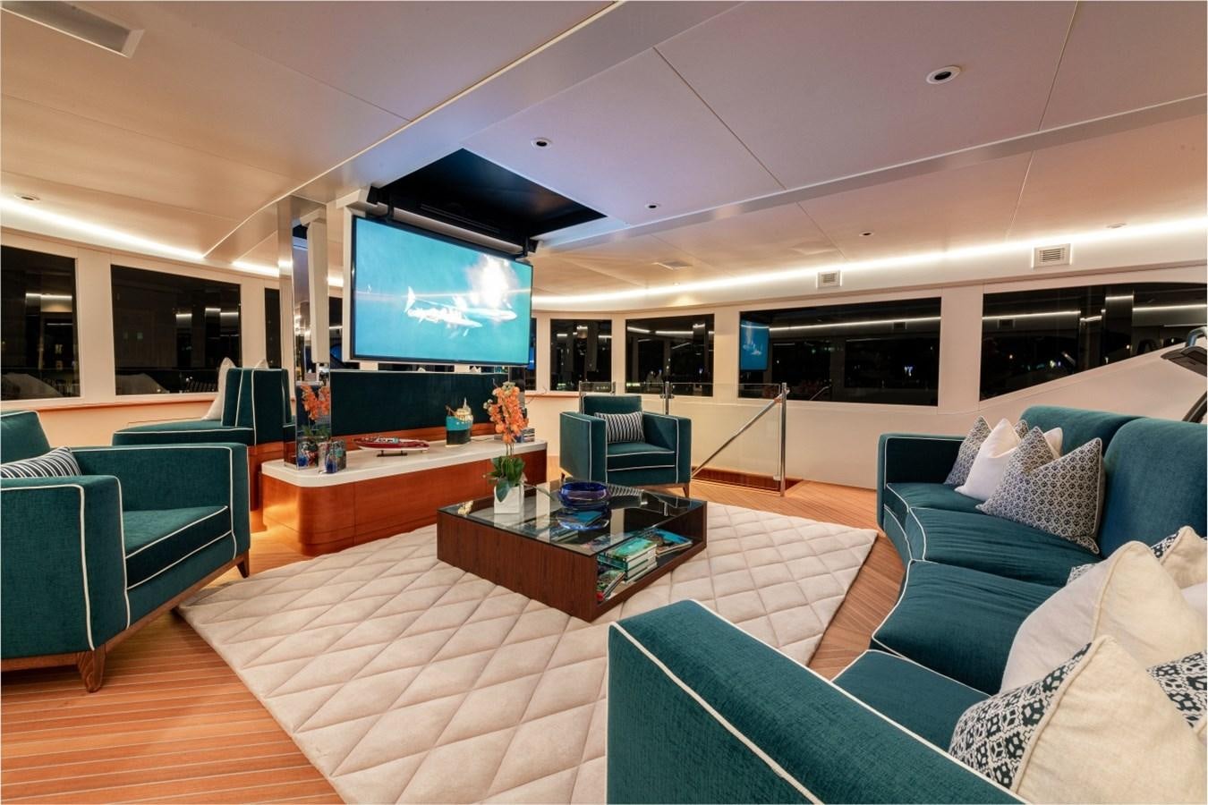 a living room with a large screen aboard WHITE STAR Yacht for Sale