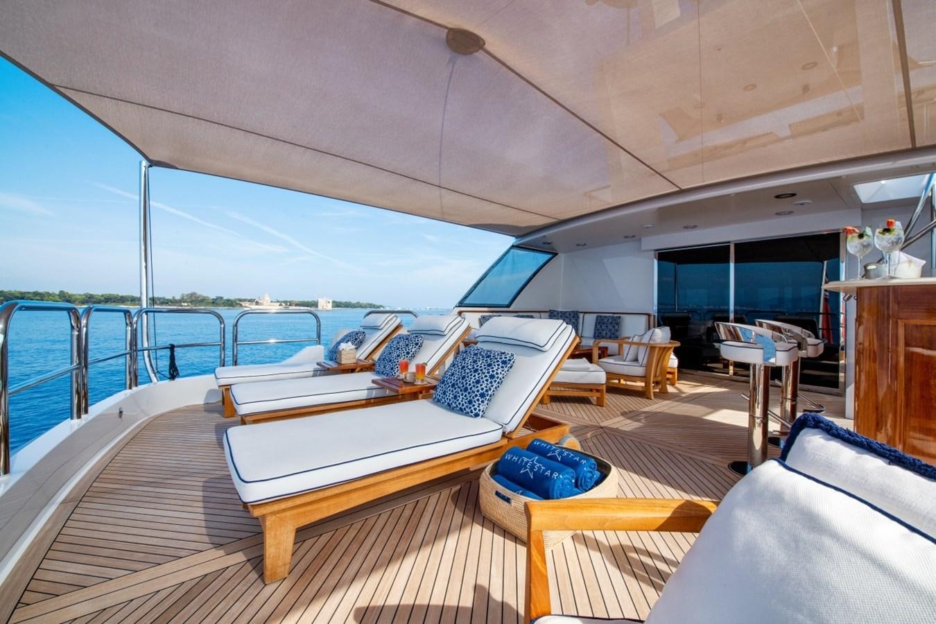 a room with a bed and a table on a deck aboard WHITE STAR Yacht for Sale