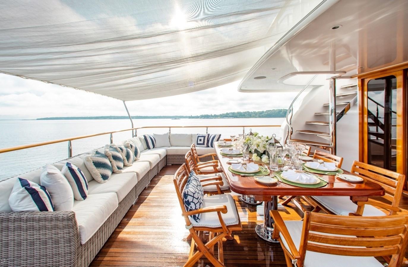 a large living room with a large patio and dining table aboard PACKAGE DEAL Yacht for Sale