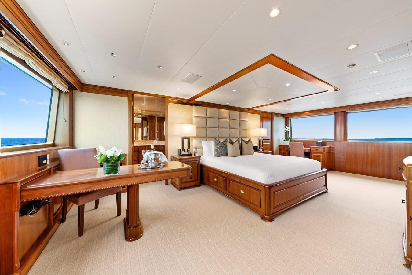 a bedroom with a bed and a table aboard PACKAGE DEAL Yacht for Sale