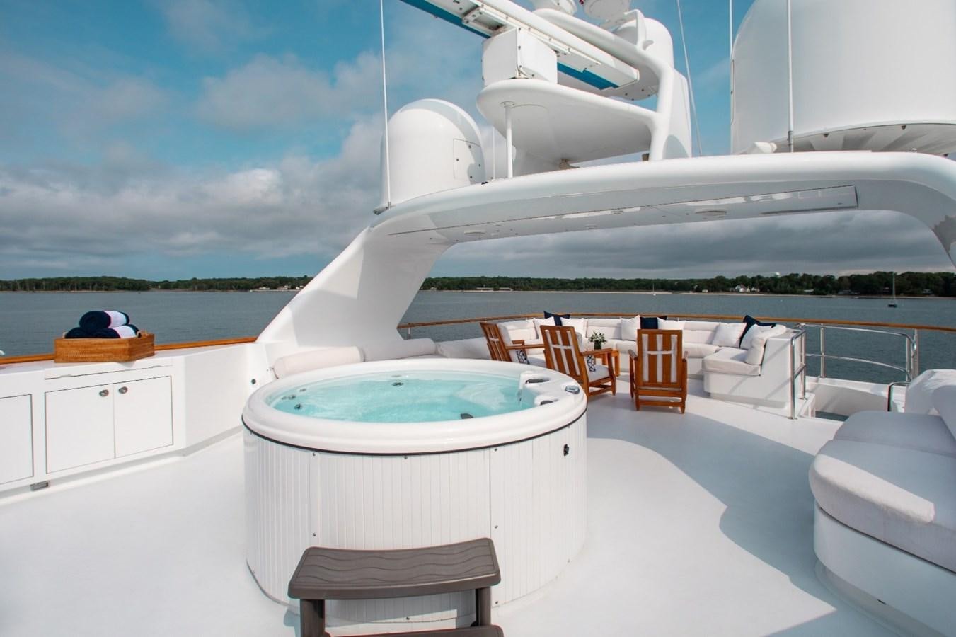 a large white boat on a white surface with chairs around it aboard PACKAGE DEAL Yacht for Sale