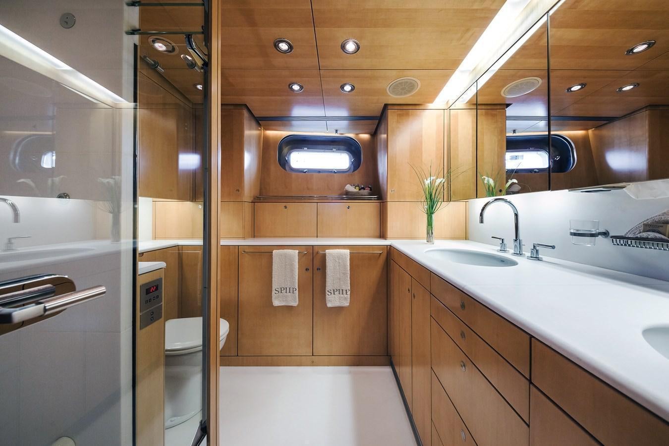 a bathroom with a glass shower aboard SPIIP Yacht for Sale