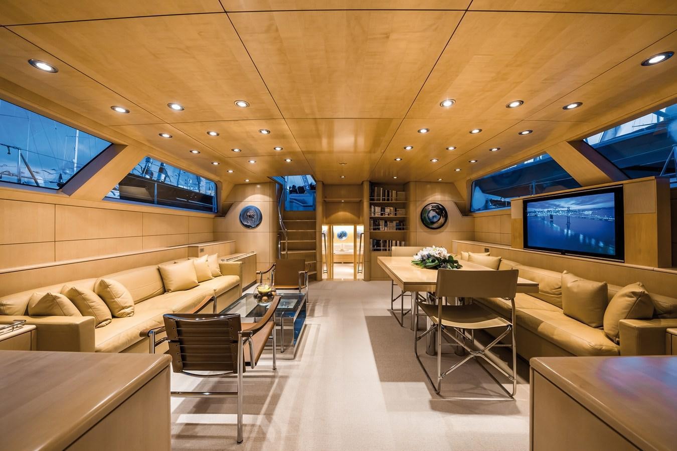 a room with a couch and a tv on the wall aboard SPIIP Yacht for Sale