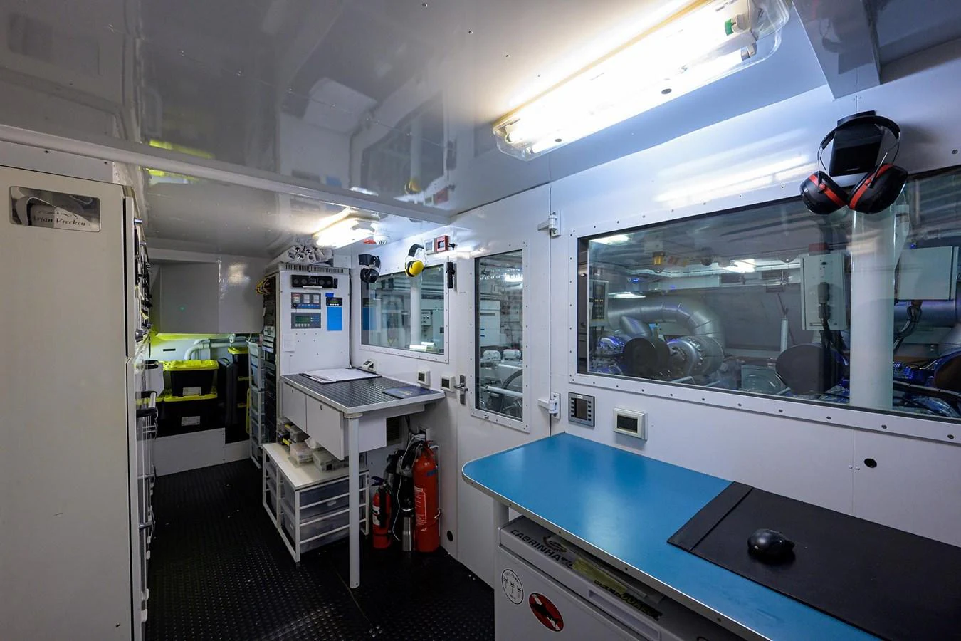 a room with a blue table and white cabinets aboard TEMPO REALE Yacht for Sale