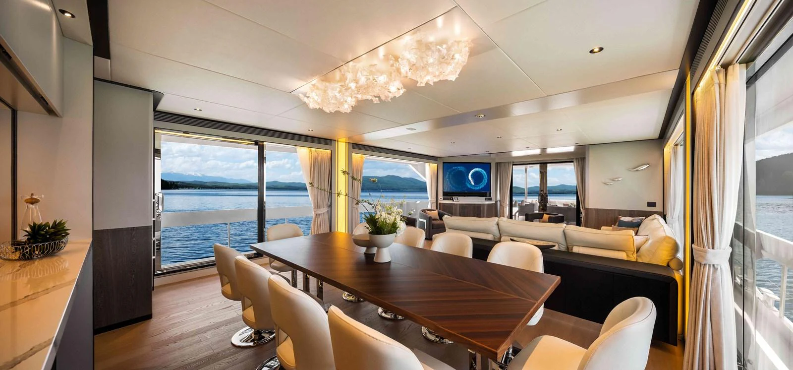 a room with a table chairs and a large window aboard FD110-004 NEW ARRIVAL Yacht for Sale