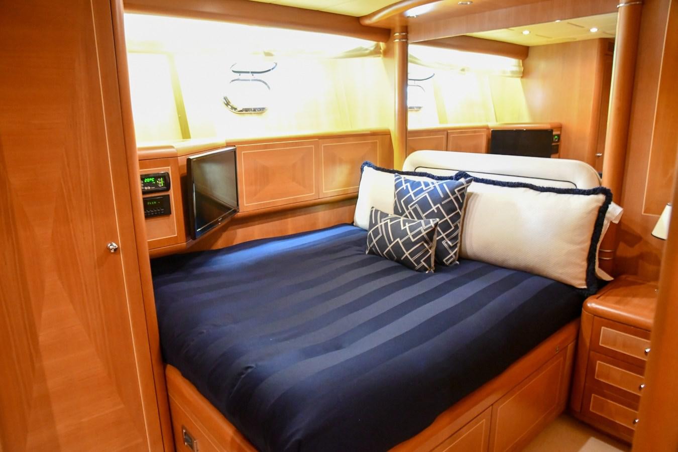 a bed with blue sheets aboard EYE PLAY Yacht for Sale