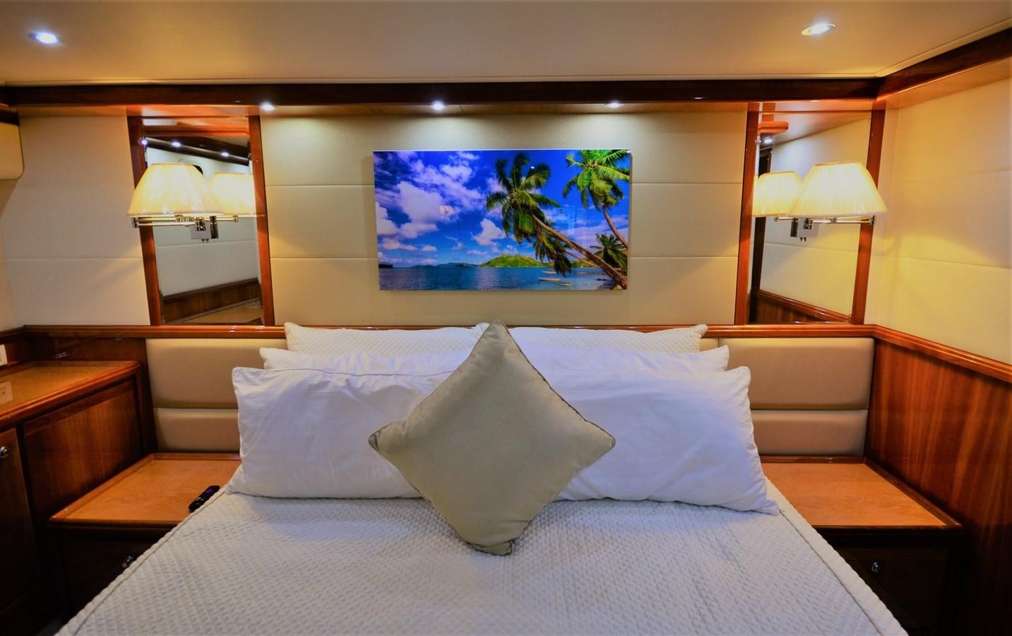 a bed with pillows and a painting on the wall aboard GABBY MILAN 2 Yacht for Sale