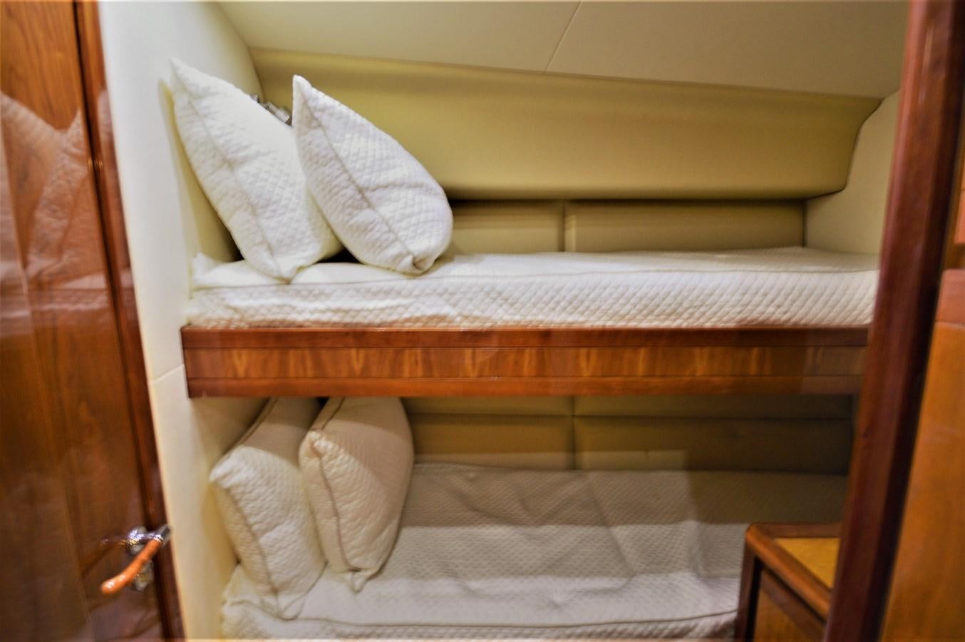 a bed with white sheets aboard GABBY MILAN 2 Yacht for Sale
