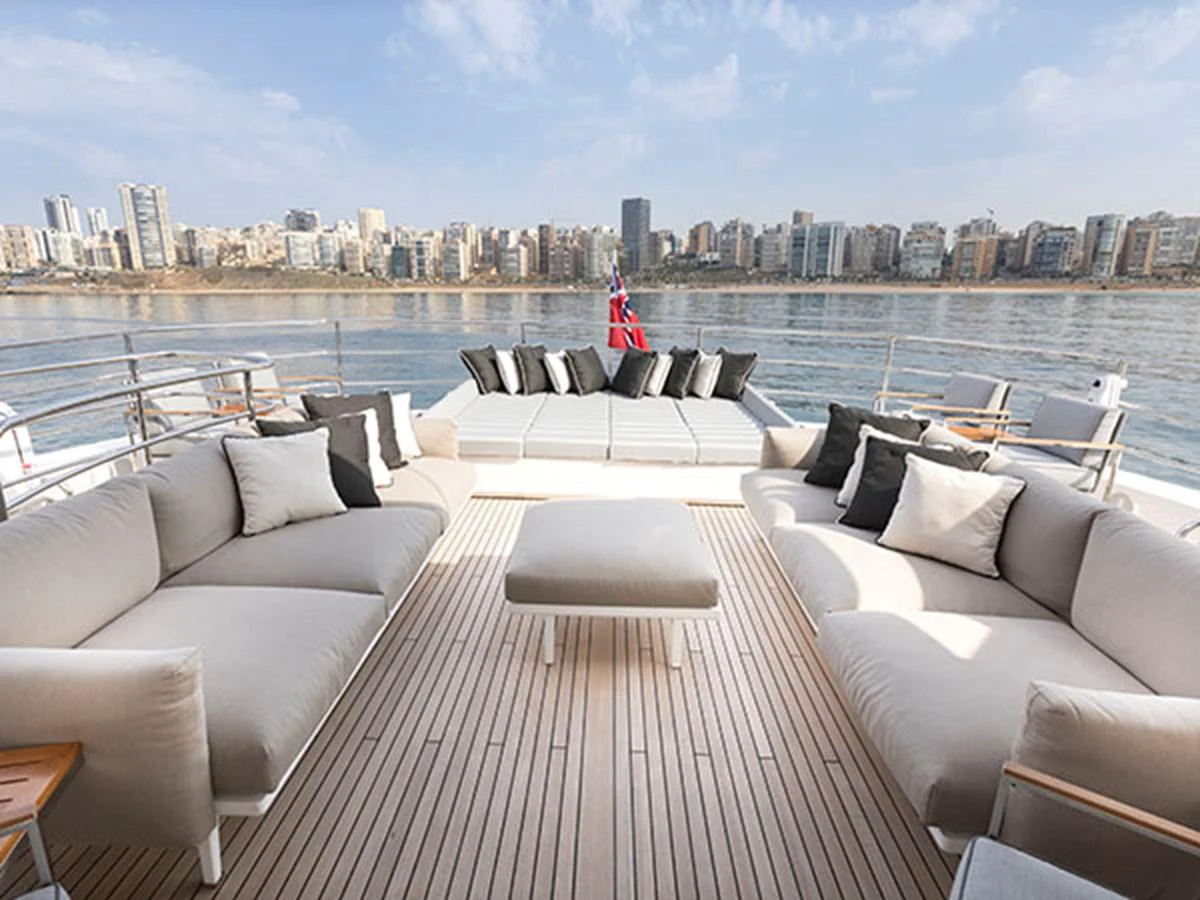 a large living room with a city skyline in the background aboard FREEDOM Yacht for Sale