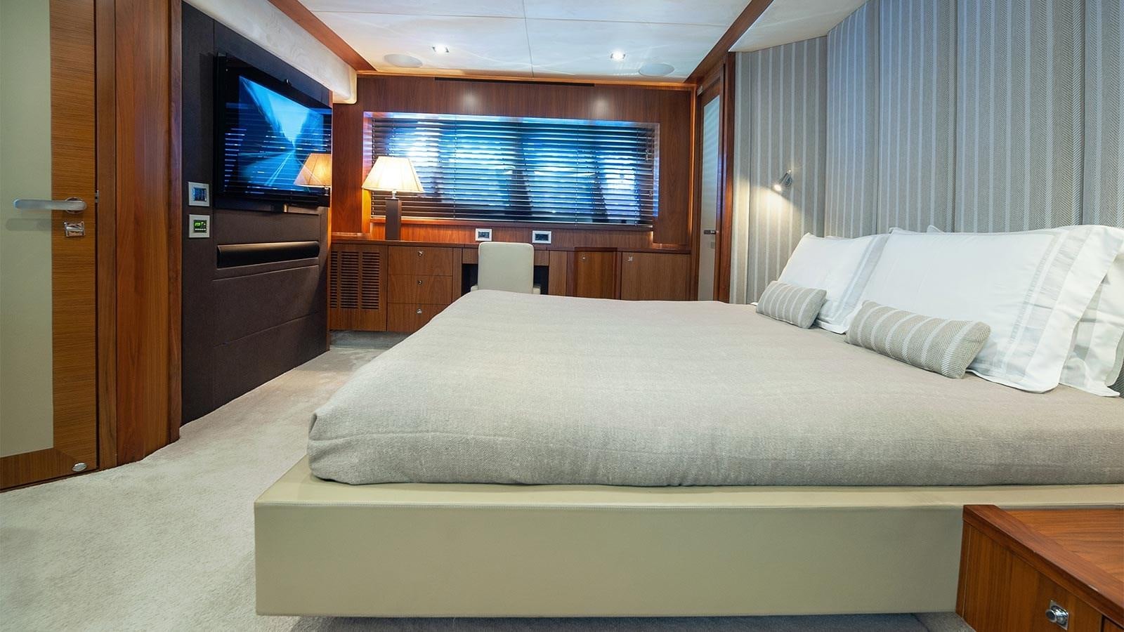 a hotel room with a bed and a tv aboard BLADE 6 Yacht for Sale