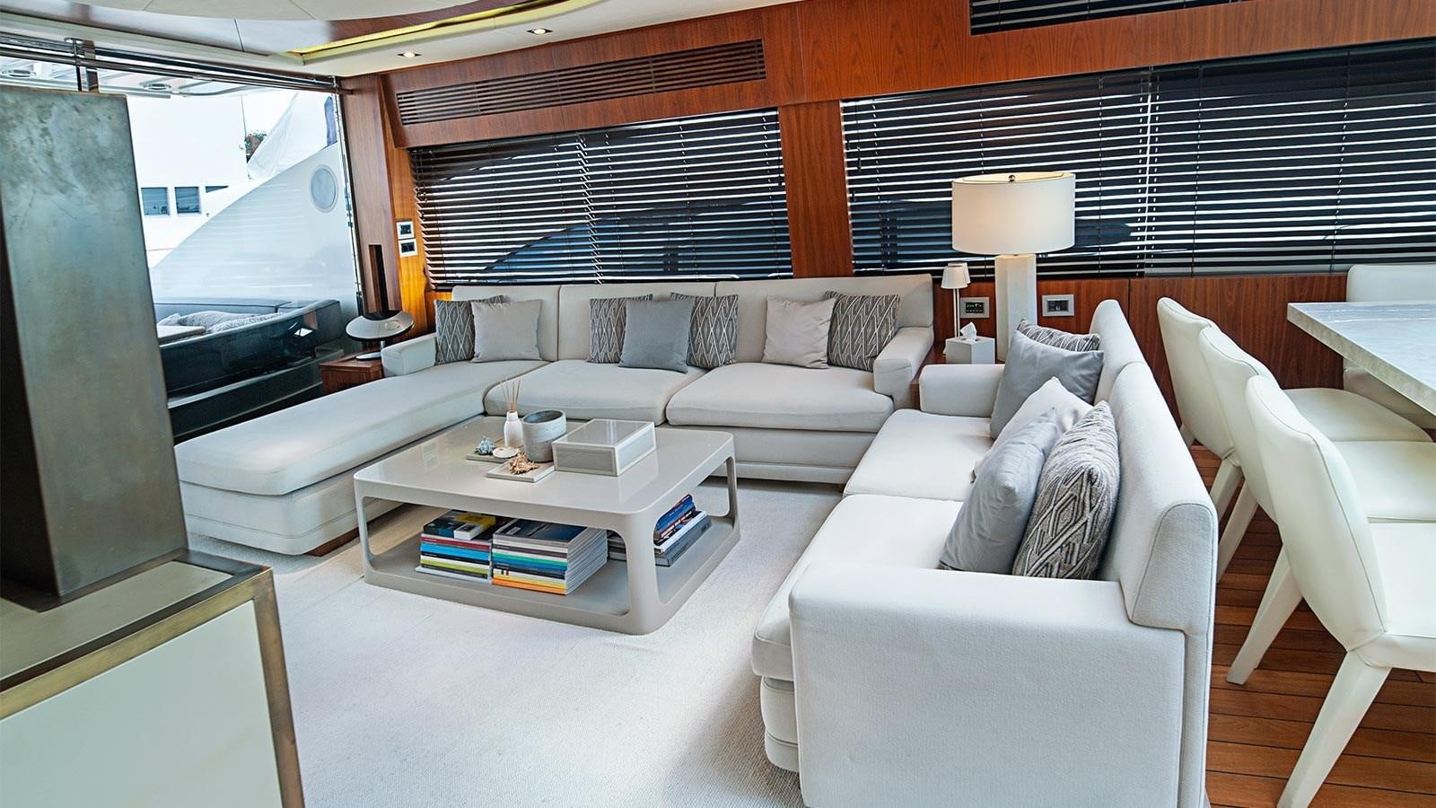 a living room with a couch and a table aboard BLADE 6 Yacht for Sale