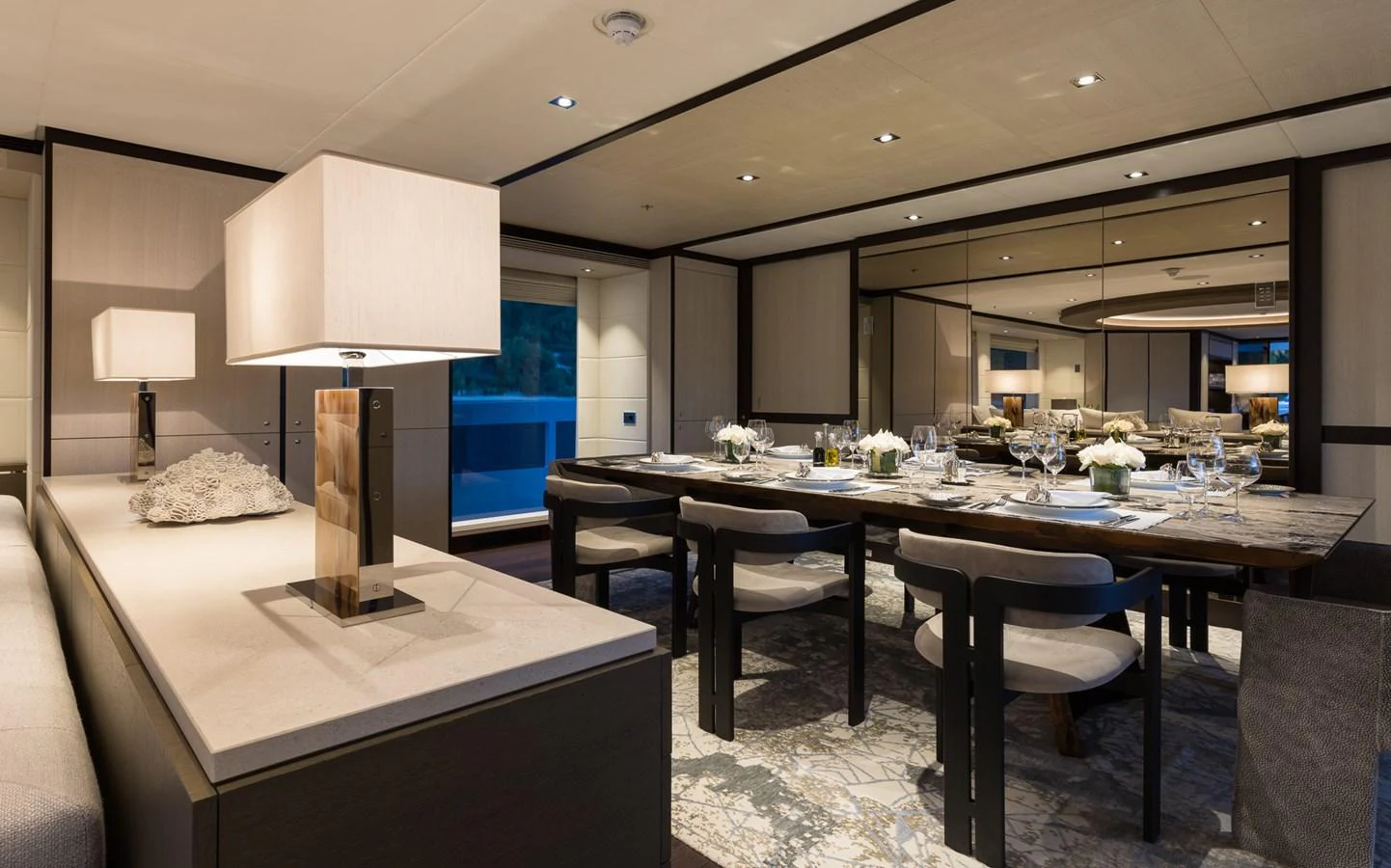 a large room with a table and chairs aboard LAURENTIA Yacht for Charter