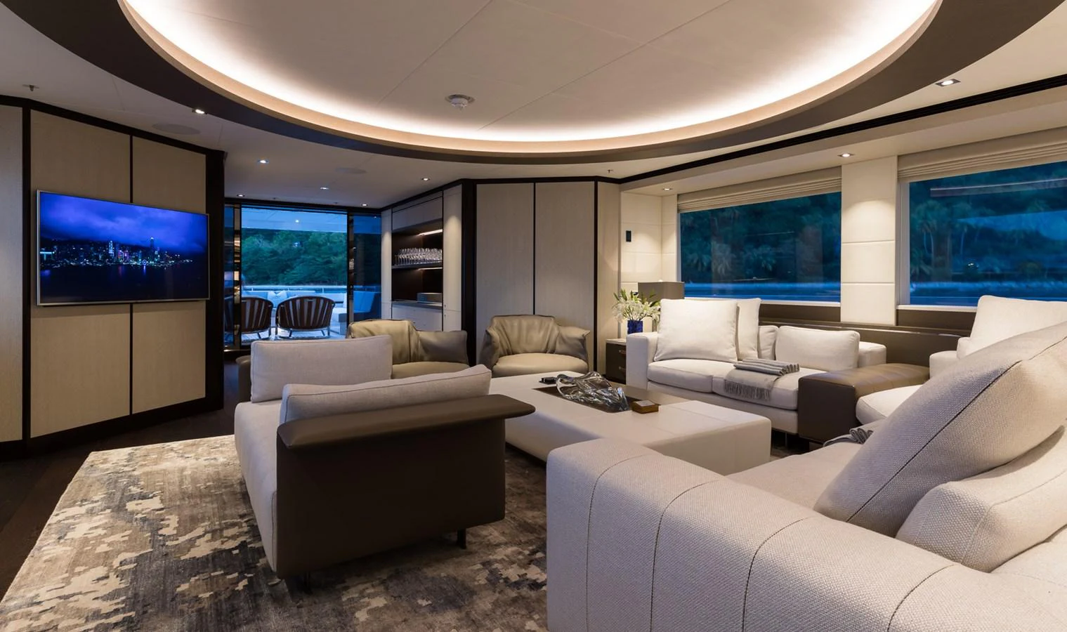 a living room with a large screen aboard LAURENTIA Yacht for Charter