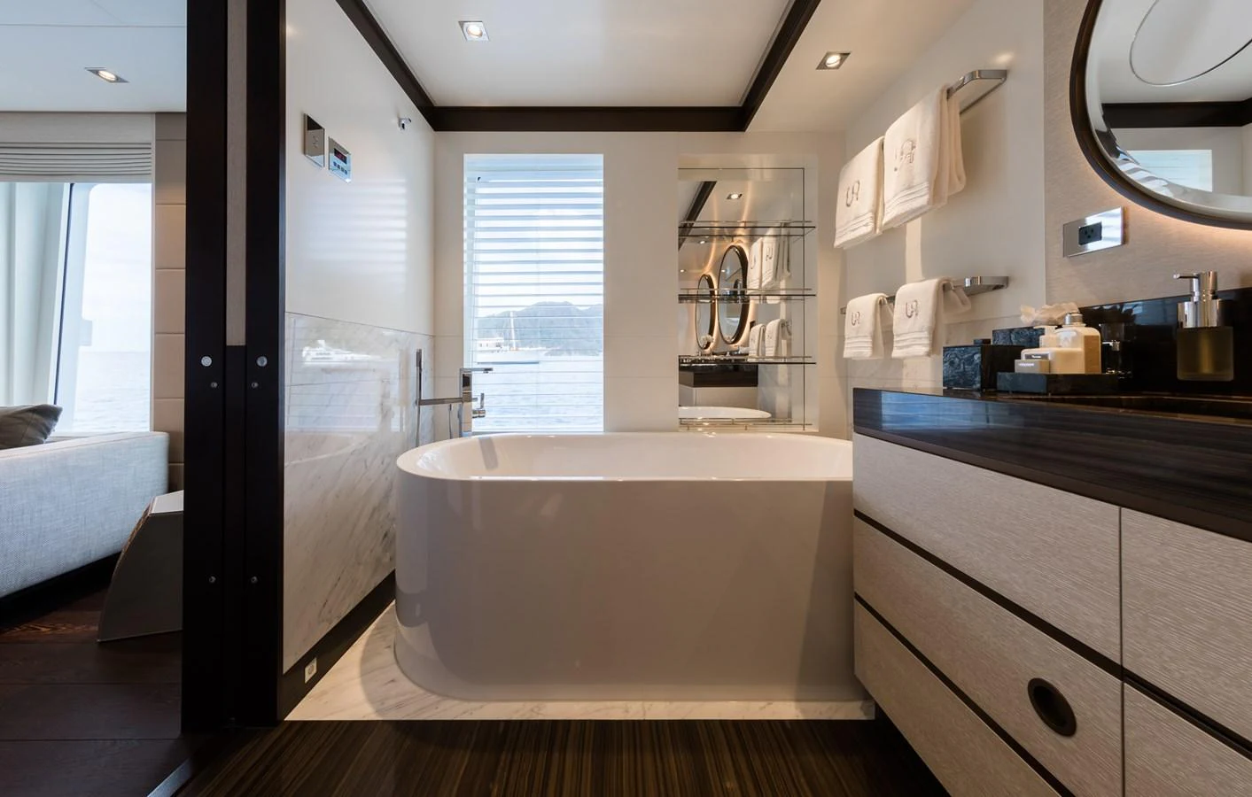 a bathroom with a tub sink and cabinets aboard LAURENTIA Yacht for Charter