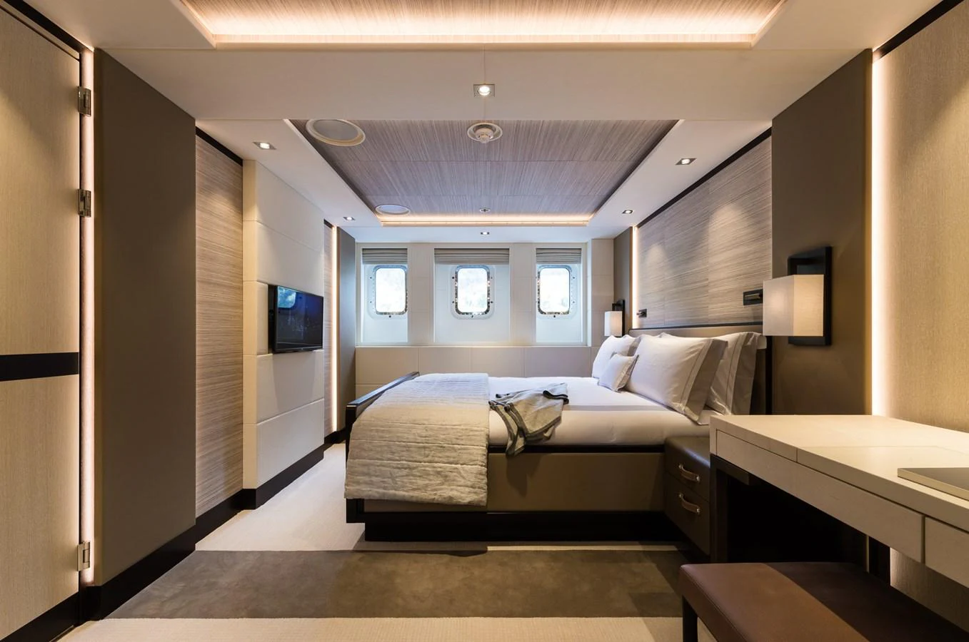 a room with a bed and a desk aboard LAURENTIA Yacht for Charter