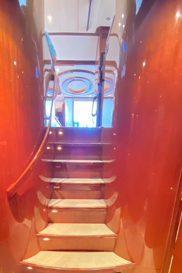 a staircase with a glass window aboard Miss Penny Yacht for Sale