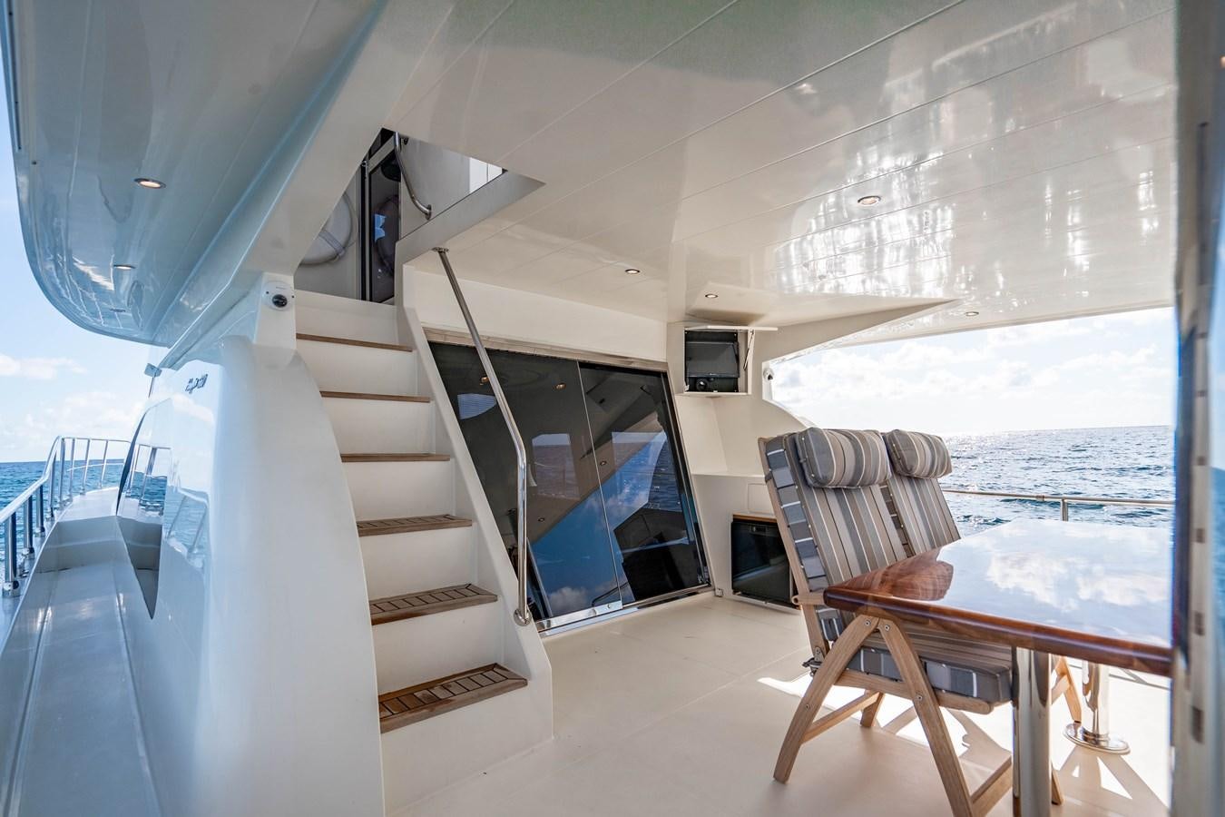 a room with a bed and a chair aboard Miss Penny Yacht for Sale