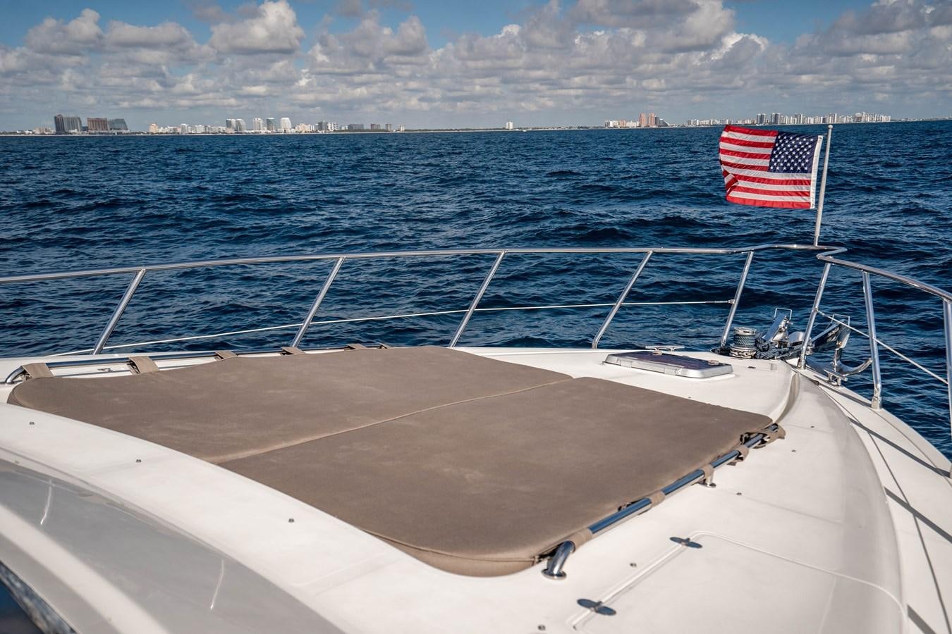 a boat with a flag on the front aboard Miss Penny Yacht for Sale