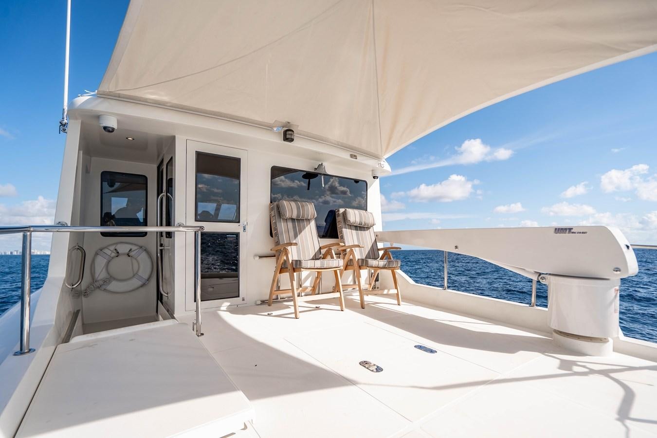 a large white house with a pool aboard Miss Penny Yacht for Sale