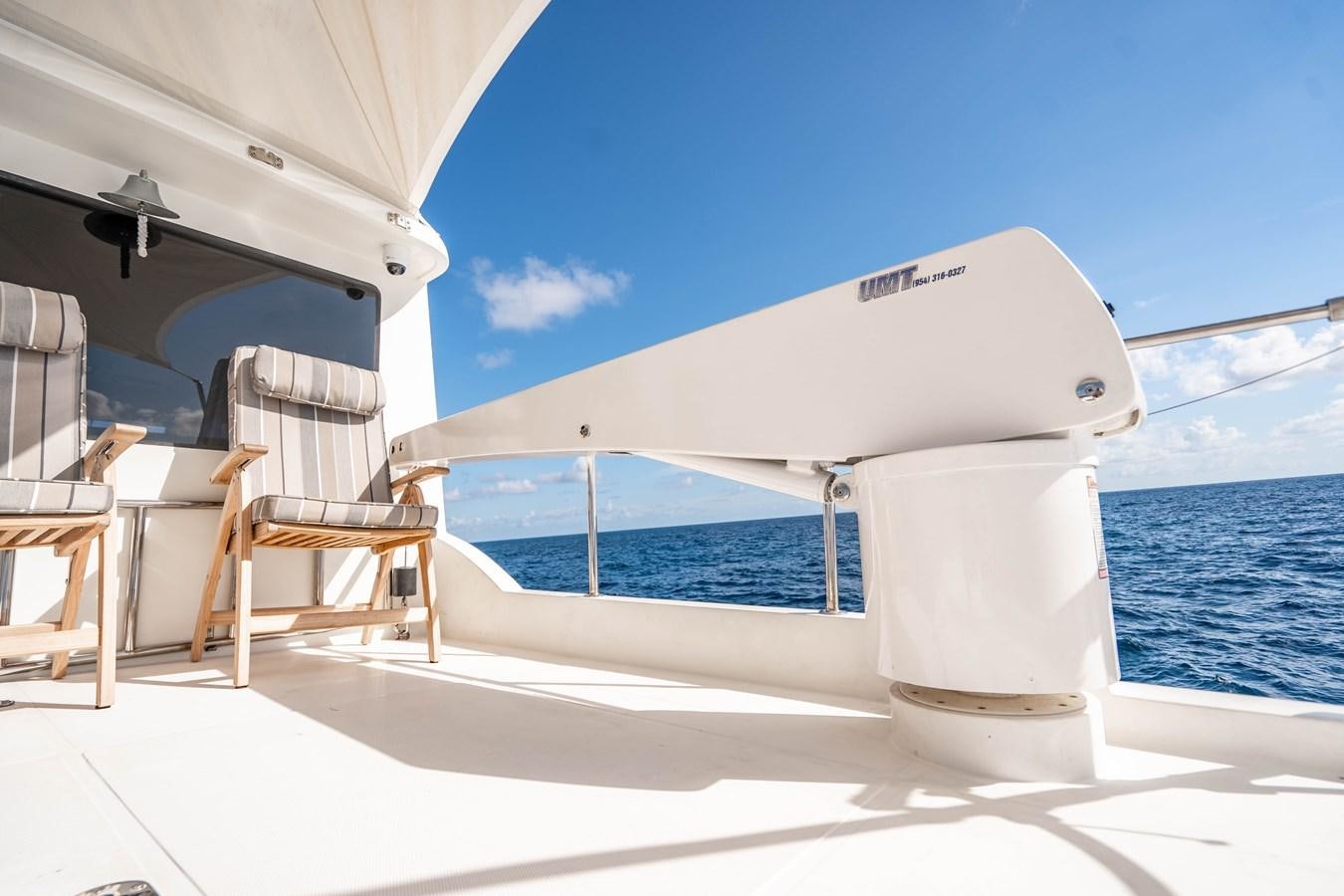 a white boat on a deck aboard Miss Penny Yacht for Sale