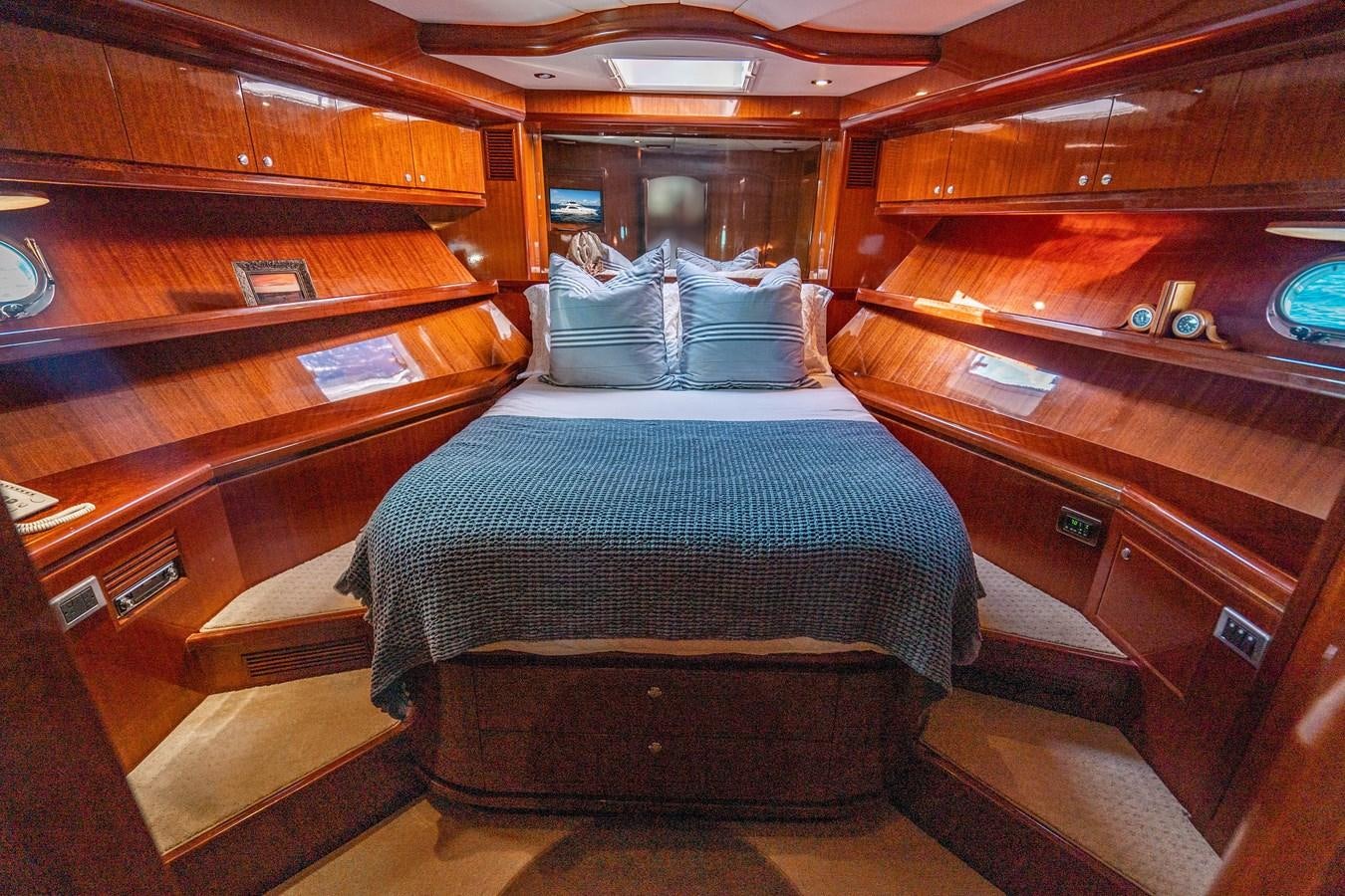 a room with a bed and a bench aboard Miss Penny Yacht for Sale