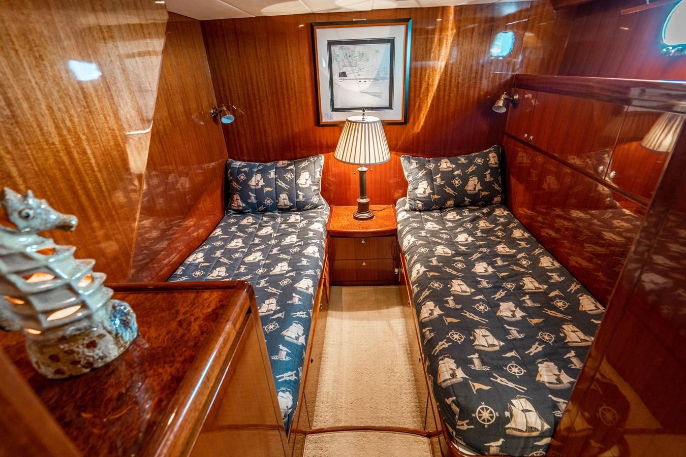 a couple of beds in a room aboard Miss Penny Yacht for Sale