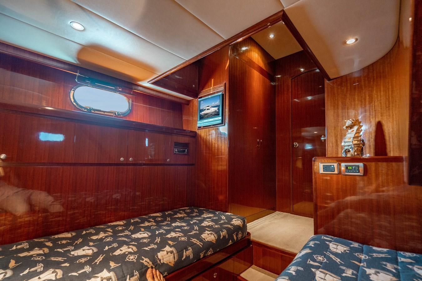 a bedroom with wood walls aboard Miss Penny Yacht for Sale