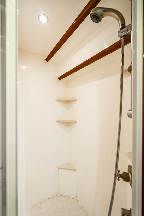 a white bathroom with a wood ceiling aboard Miss Penny Yacht for Sale