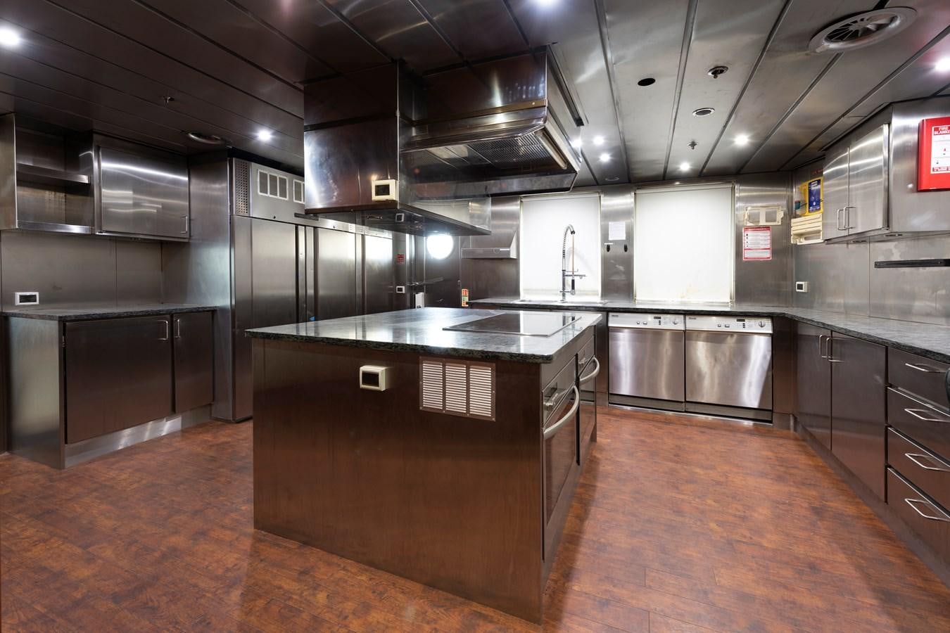 a large kitchen with stainless steel appliances aboard BIG ARON Yacht for Sale